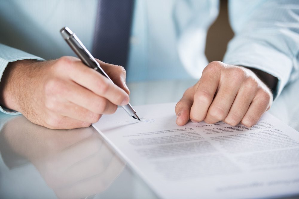 real estate lawyer signing a contract